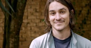 videoblocks-portrait-of-a-handsome-man-in-his-20s-or-30s-with-long-hair-smiling-and-looking-at-the-camera_scecjislt_thumbnail-small02.jpg